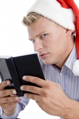 Man Holding a Book and Looking Askance from FreeDigitalPhotos.net